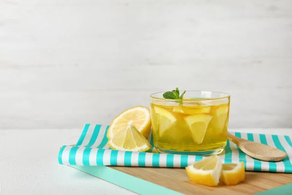 Glass of lemon jelly served on white table against light background. Space for text
