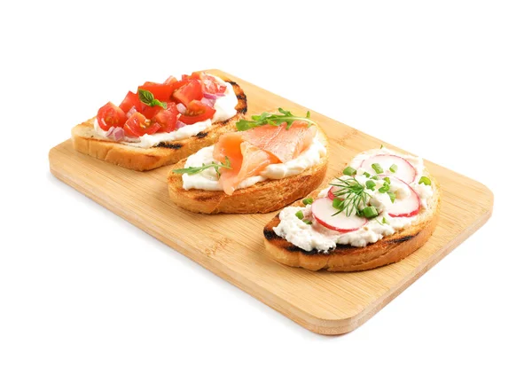 Board with different tasty bruschettas on white background — Stock Photo, Image