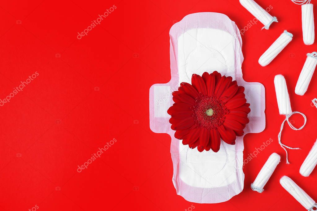 Different feminine hygiene products and flower on color background, flat lay with space for text. Gynecological care