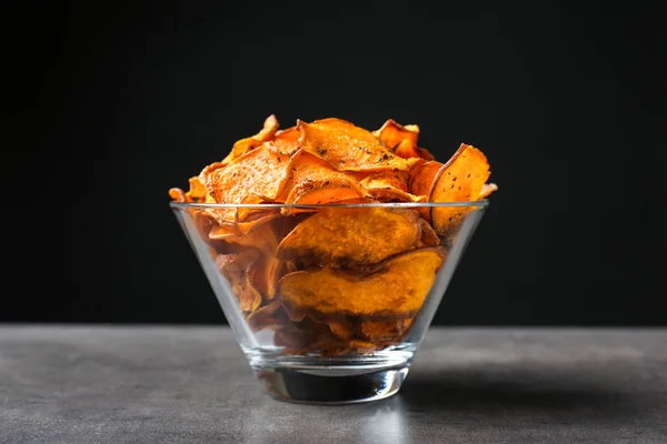 Cuenco con patatas fritas en la mesa sobre fondo negro —  Fotos de Stock