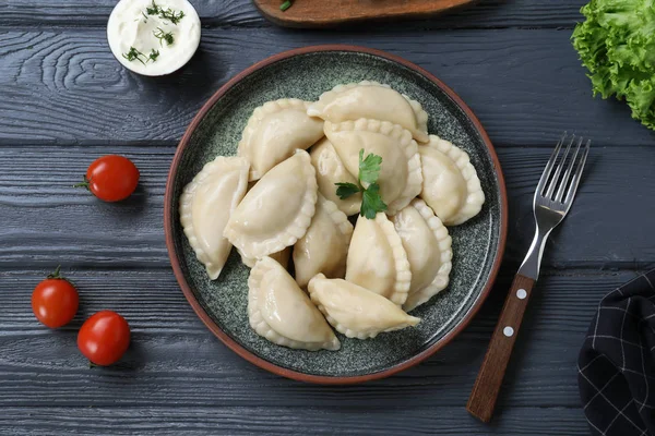Flat lay composition with tasty dumplings served on wooden table — Stock Photo, Image