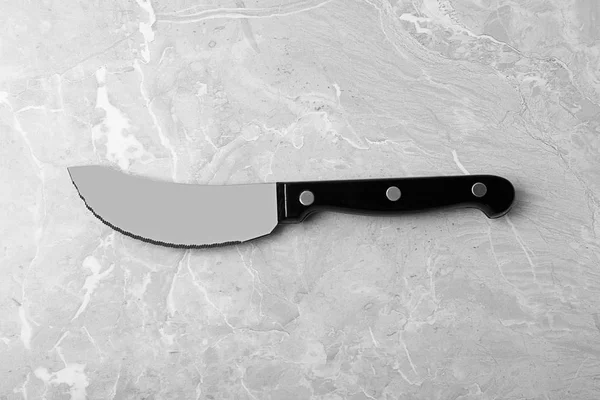 Sharp pizza knife on grey background, top view