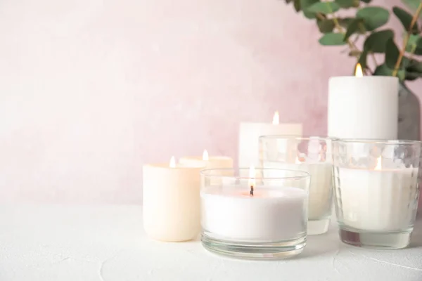 Burning aromatic candles in holders on table. Space for text — Stock Photo, Image