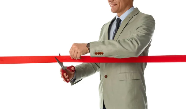 Man in office suit cutting red ribbon isolated on white, closeup — Stock Photo, Image