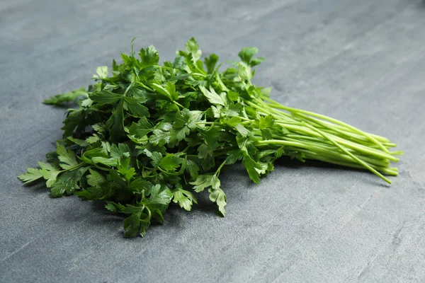 Bunch of fresh green parsley on grey background
