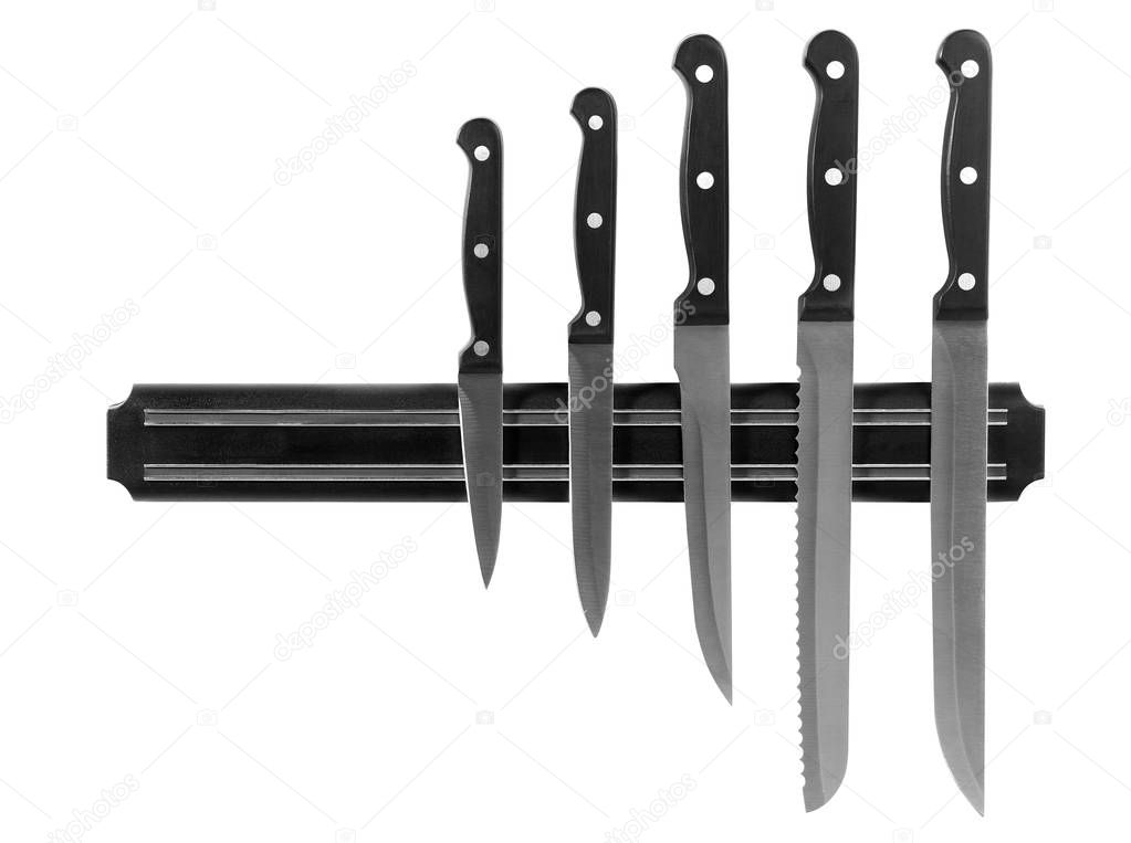 Magnetic holder with different knives isolated on white