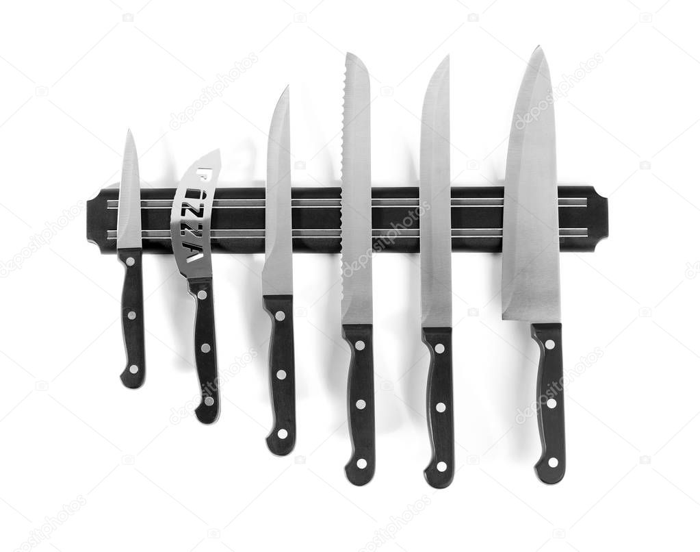 Magnetic holder with different knives isolated on white