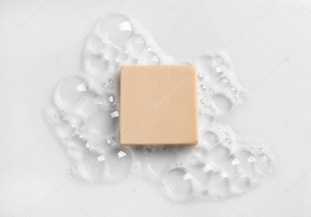 Soap bar and foam on white background, top view. Mockup for design