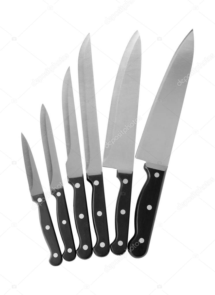 Set of sharp knives on white background, top view