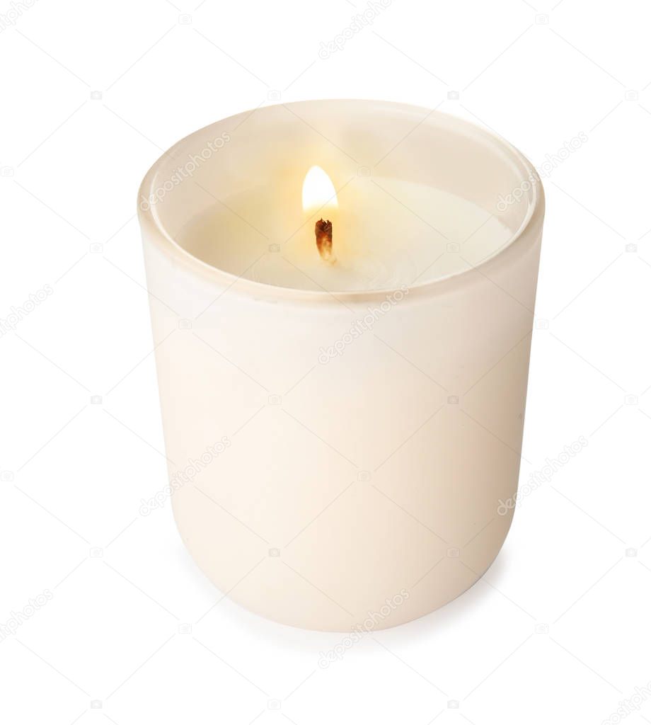 Burning candle in glass holder on white background