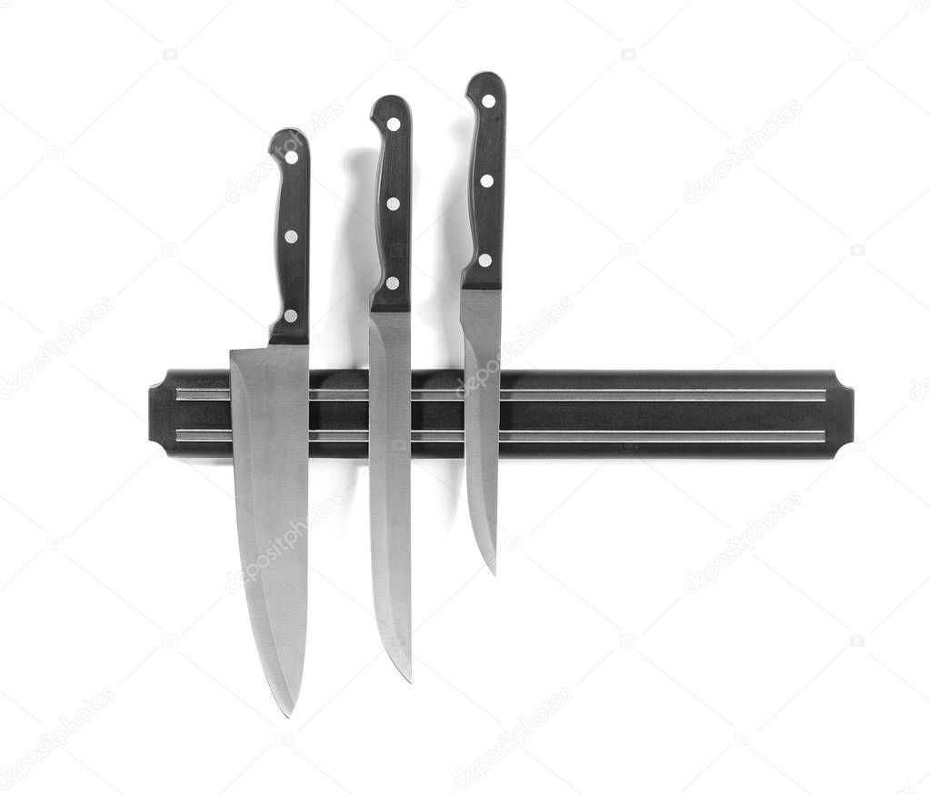 Magnetic holder with different knives isolated on white