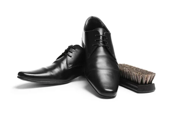 Stylish men's shoes and cleaning brush on white background — Stock Photo, Image