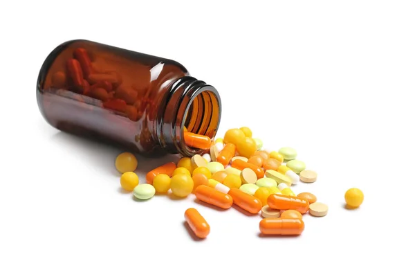 Fles met vitaminepillen en capsules op witte achtergrond — Stockfoto