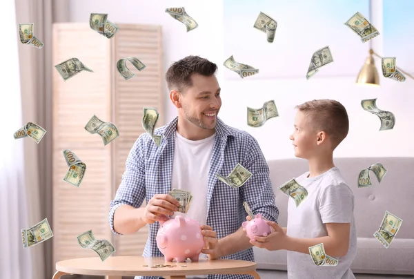 Family with piggy banks and money at home — Stock Photo, Image