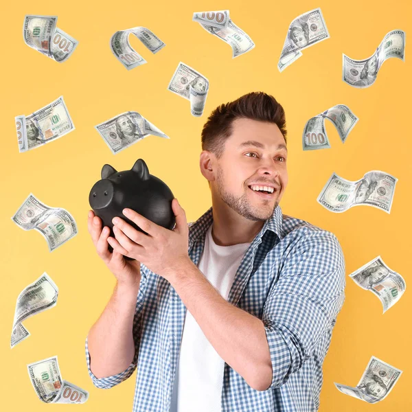 Щасливий чоловік з скарбничкою і літаючими грошима на кольоровому фоні — стокове фото