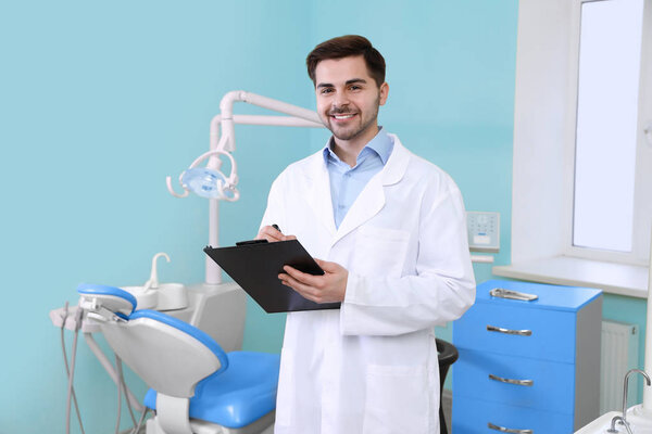 Portrait of male dentist in modern clinic