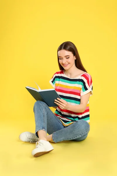 Fiatal nő olvasott könyv színes háttér, hely a szöveg — Stock Fotó
