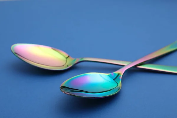 New clean colorful tablespoons on blue background — Stock Photo, Image