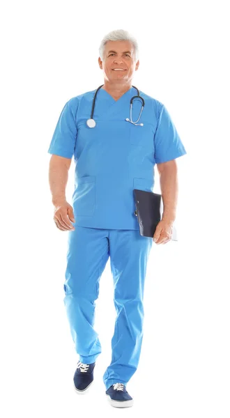 Full length portrait of male doctor in scrubs with clipboard isolated on white. Medical staff — Stock Photo, Image