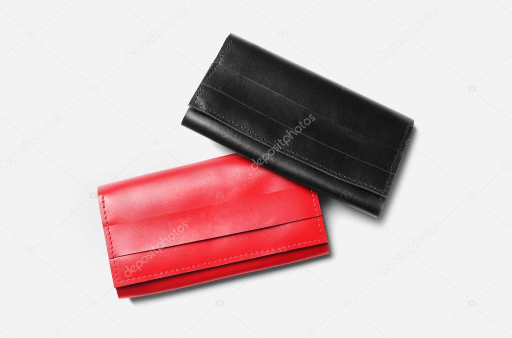 Stylish leather wallets on white background, top view