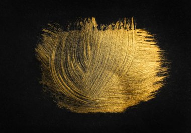 Siyah arka planda altın boya fırçası vuruşları