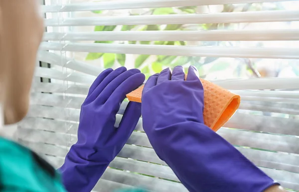 Femme essuyant les stores de fenêtre avec chiffon à l'intérieur, gros plan. Avant et après le nettoyage — Photo
