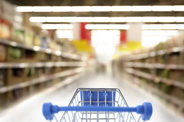 Niewyraźne widok na supermarket i pusty koszyk — Zdjęcie stockowe