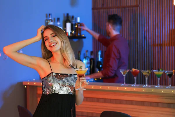 Mulher bonita com copo de martini cocktail no bar, espaço para texto — Fotografia de Stock