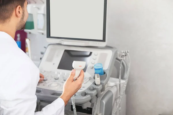 Sonographer using modern ultrasound machine in clinic, space for text — Stock Photo, Image