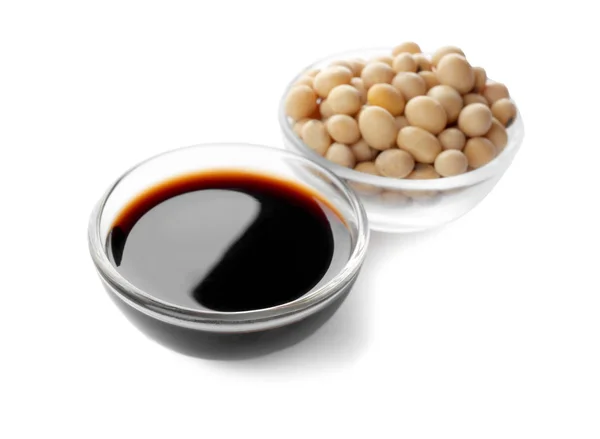 Bowl of tasty soy sauce and beans isolated on white Royalty Free Stock Photos