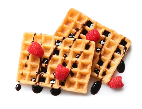 Delicious waffles with raspberries and chocolate syrup on white background, top view — Stock Photo, Image