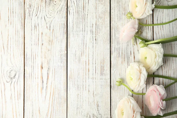 Beautiful ranunculus flowers and space for text on wooden background, flat lay — Stock Photo, Image