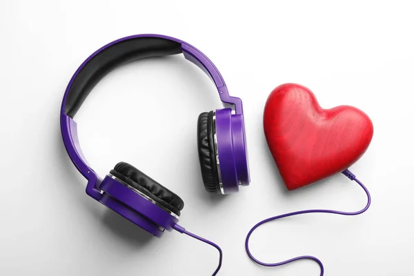 Διακοσμητική καρδιά και μοντέρνα ακουστικά σε λευκό φόντο, κορυφή θέα — Φωτογραφία Αρχείου