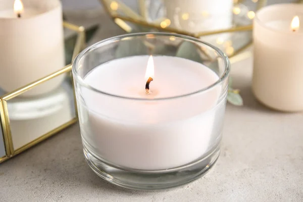 Burning aromatic candle in holder on table — Stock Photo, Image