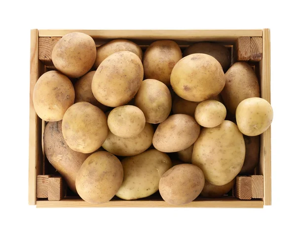 Wooden crate full of fresh raw potatoes on white background, top view — Stock Photo, Image