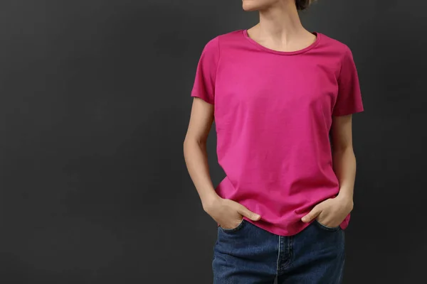 Woman in bright t-shirt on dark background. Mock up for design