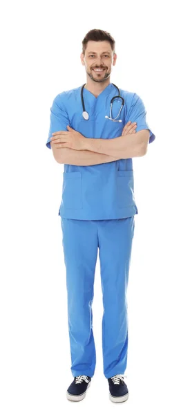 Full length portrait of smiling male doctor in scrubs isolated on white. Medical staff — Stock Photo, Image