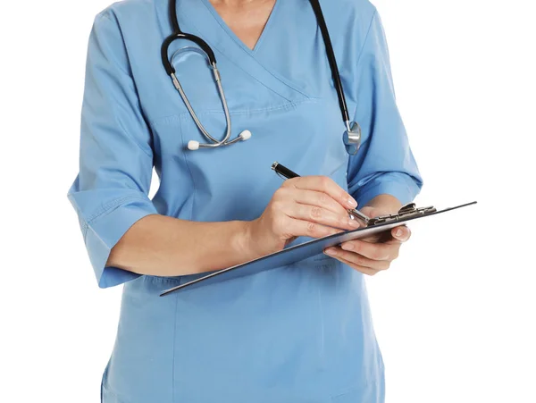 Closeup of female doctor in scrubs with clipboard isolated on white. Medical staff — Stock Photo, Image