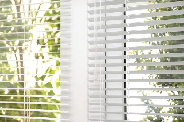 Open white horizontal window blinds, closeup view