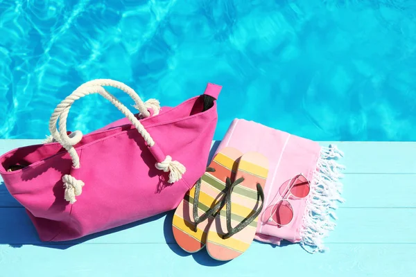 Strand accessoires op houten dek in de buurt van het zwembad. Ruimte voor tekst — Stockfoto