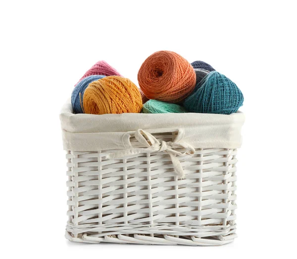 Wicker basket with clews of colorful knitting threads on white background — 스톡 사진
