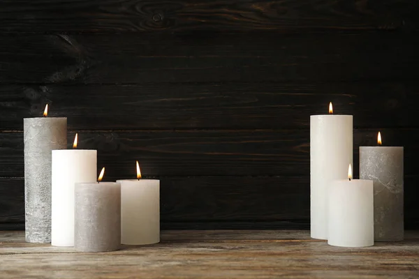Alight wax candles on table. Space for text — Stock Photo, Image
