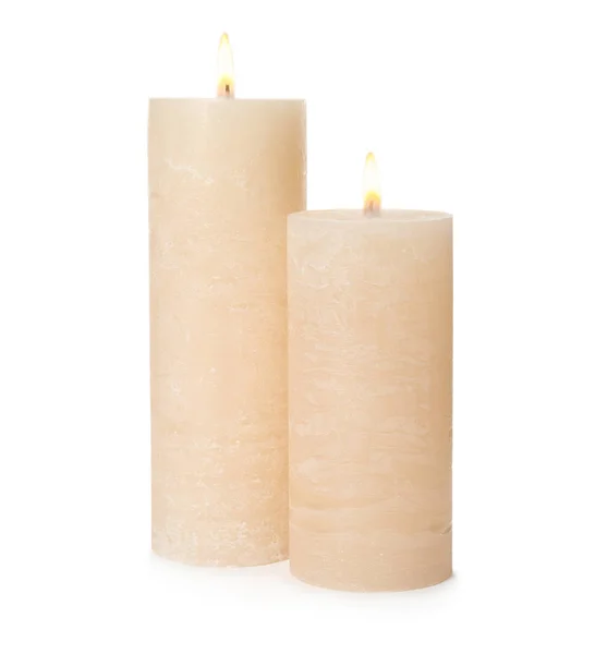 Dvě zapálené voskové svíčky na bílém pozadí — Stock fotografie