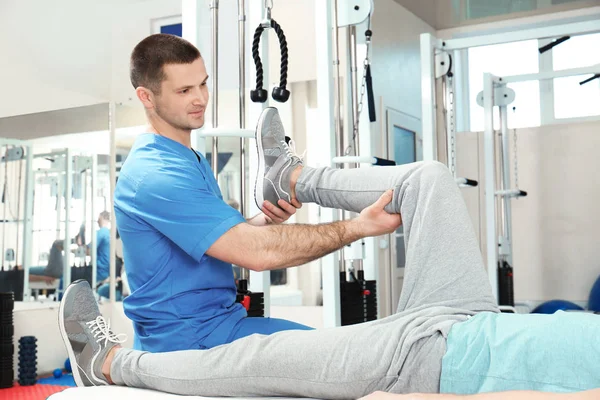 Physiotherapist working with patient in rehabilitation center — Stock Photo, Image