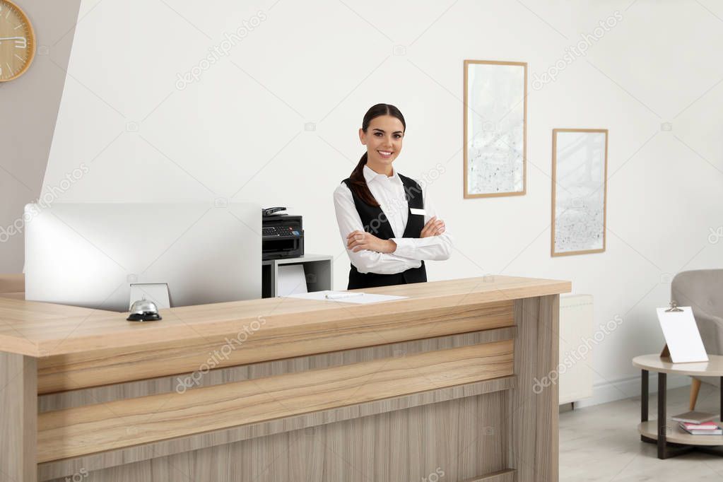 Portrait of receptionist at desk in modern hotel