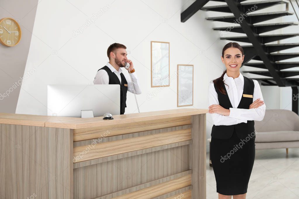 Young receptionists in professional uniform at workplace