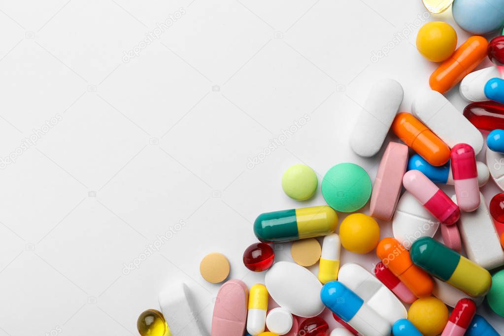 Different pills on white background, top view