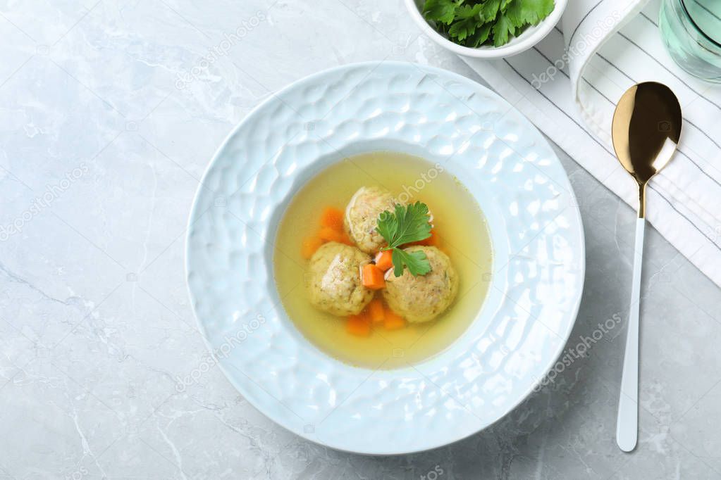 Flat lay composition with Jewish matzoh balls soup on light table
