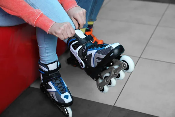 Woman putting on roller skates indoors, closeup — 스톡 사진