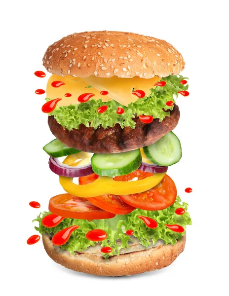 Delicious burger with different flying ingredients on white background — Stock Photo, Image